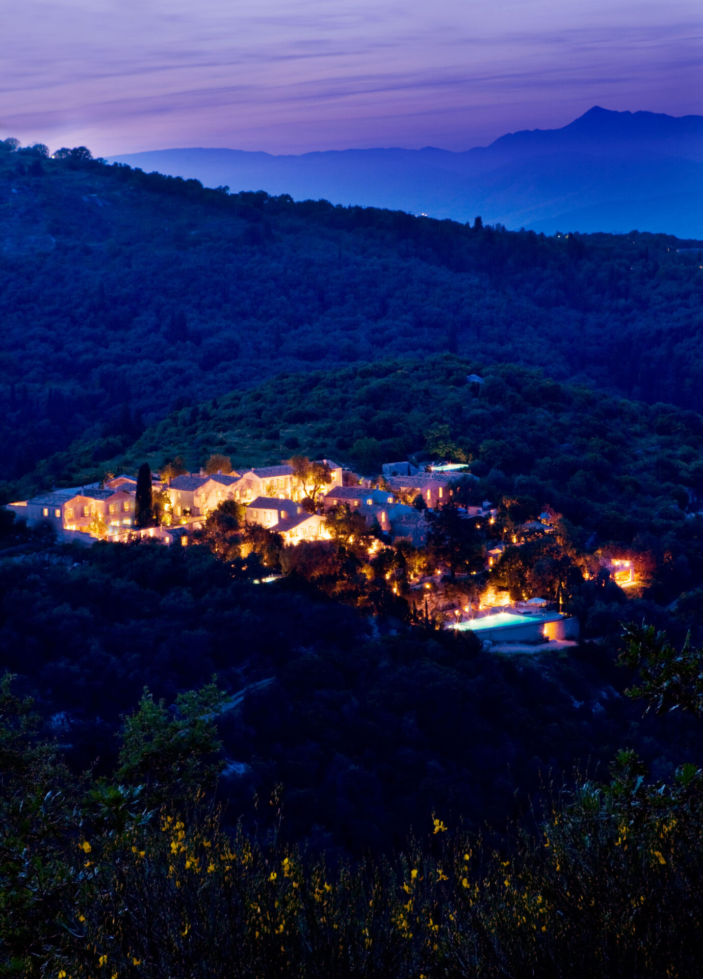 The Rou Estate Corfu at night with lighting and the albanian mountains in view beyond